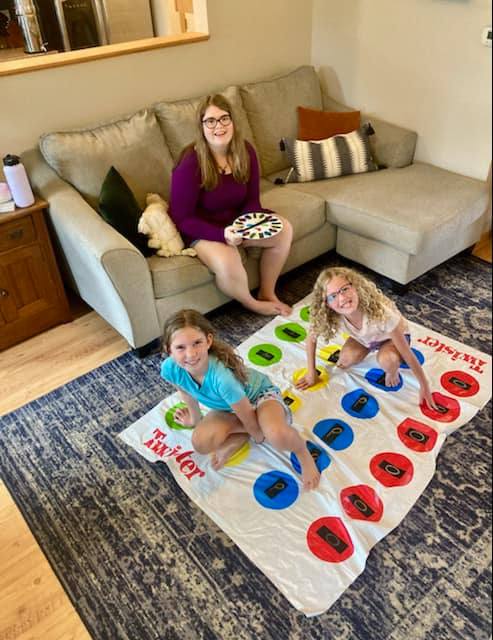 Theory party image of children playing on the twister game.